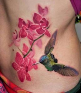 Hummingbird tattoo with flowers