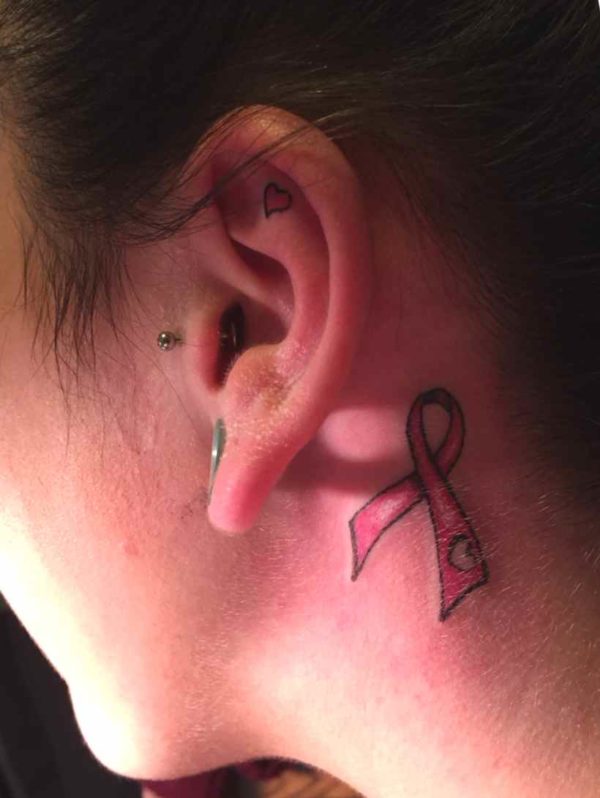 Ribbon tattoo behind the ear