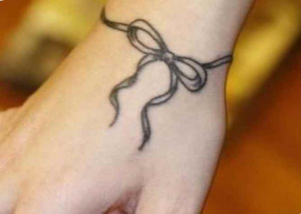 Ribbon tattoo around the wrist
