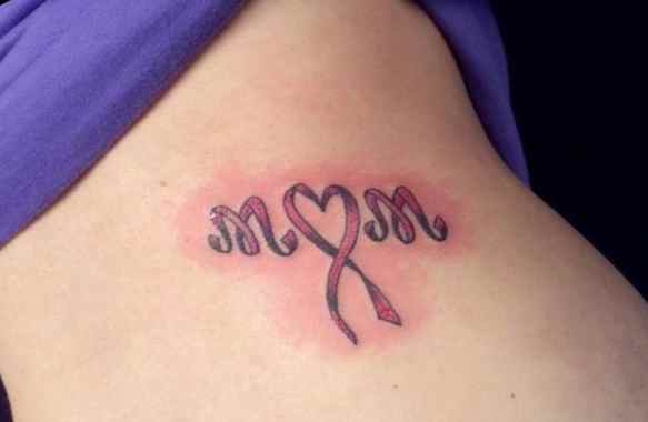 Cancer ribbon tattoo incorporating initials