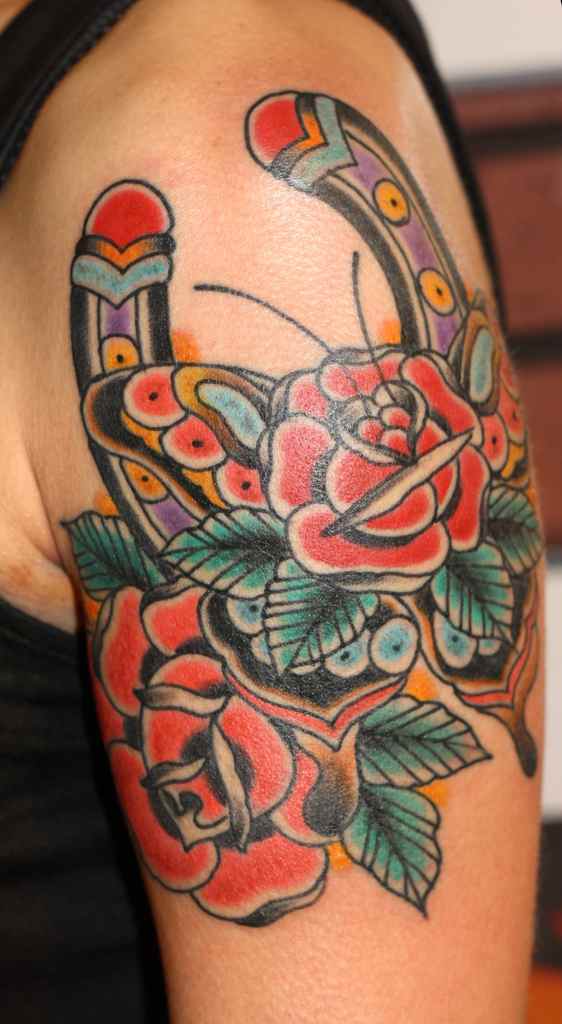 Red flowers and horse shoe tattoo