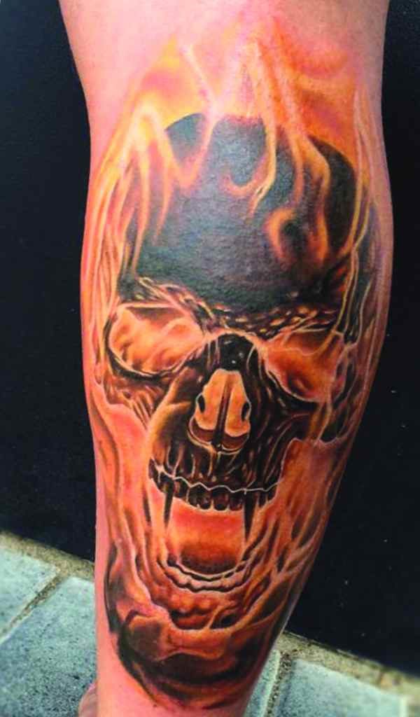 Skull and flame sleeve tattoo