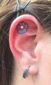 Flower ear tattoo with piercing