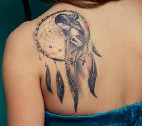 Dreamcatcher tattoo on her shoulder