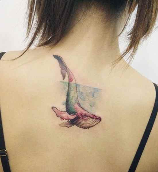 Whales tail back tattoo for girls