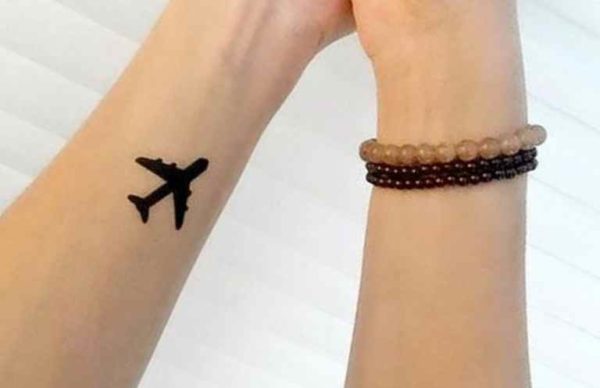 Plane black wrist tattoo