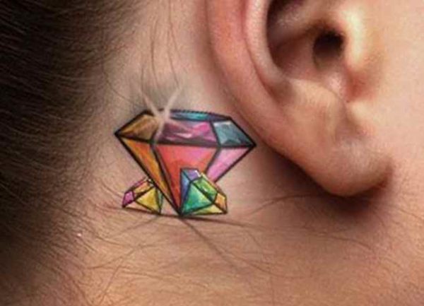 Colored tattoo diamond behind the ear