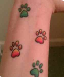 Colorful pawprints dog tattoo