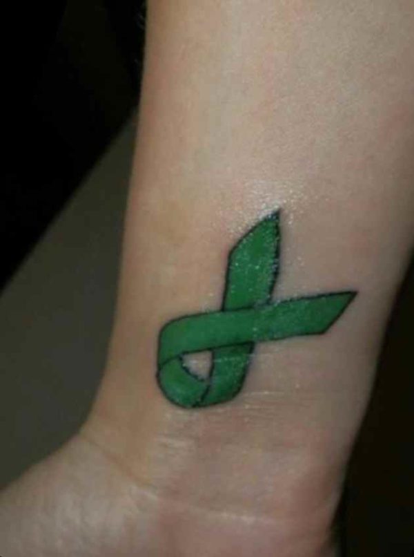 Cancer ribbon tattoo on wrist
