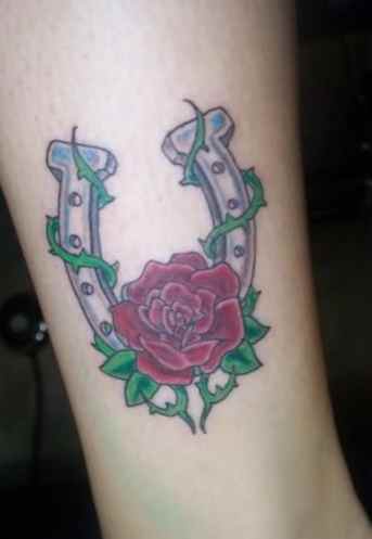 Simple rose and horse shoe tattoo