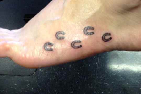 Small foots horse shoe tattoo