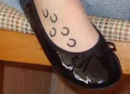 Small womens foots horse shoe tattoo