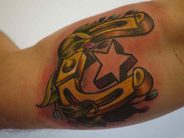Star and yellow horse shoe tattoo